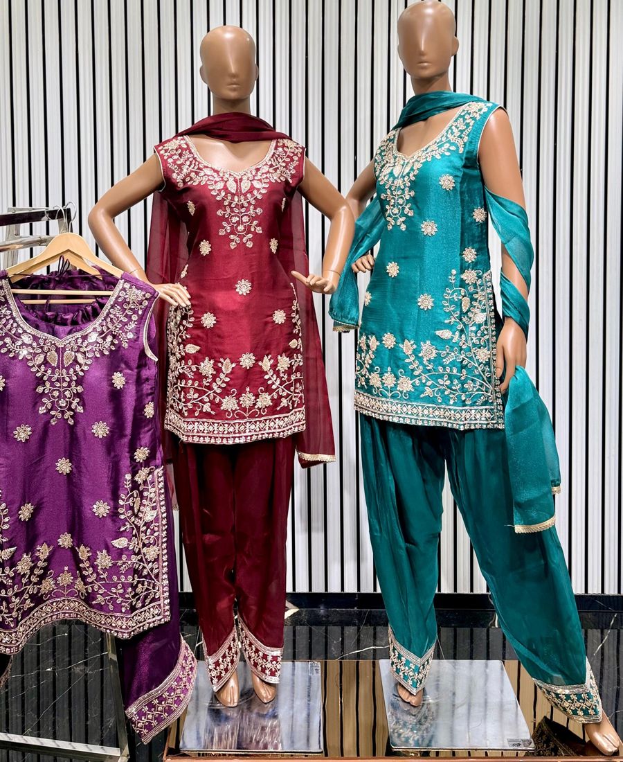Maroon and teal salwar suits with embroidered hem